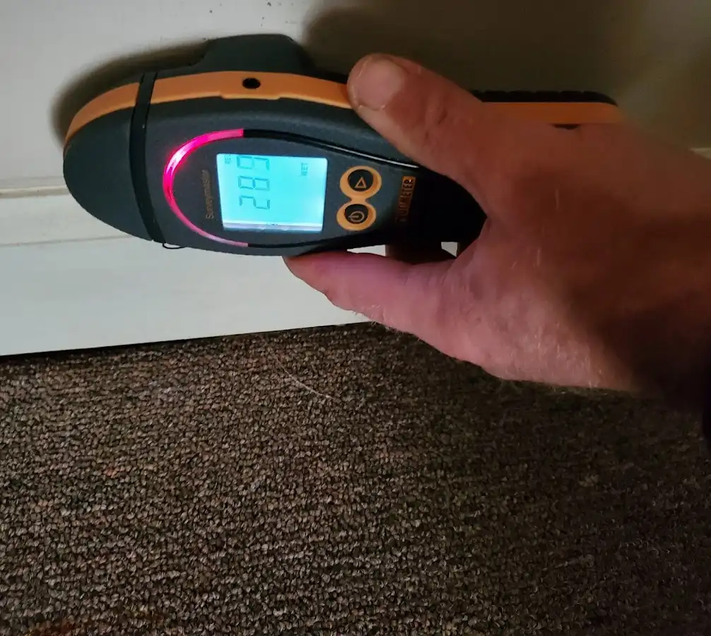 Moisture detection at baseboard during Storm Damage Restoration in St. Martin
